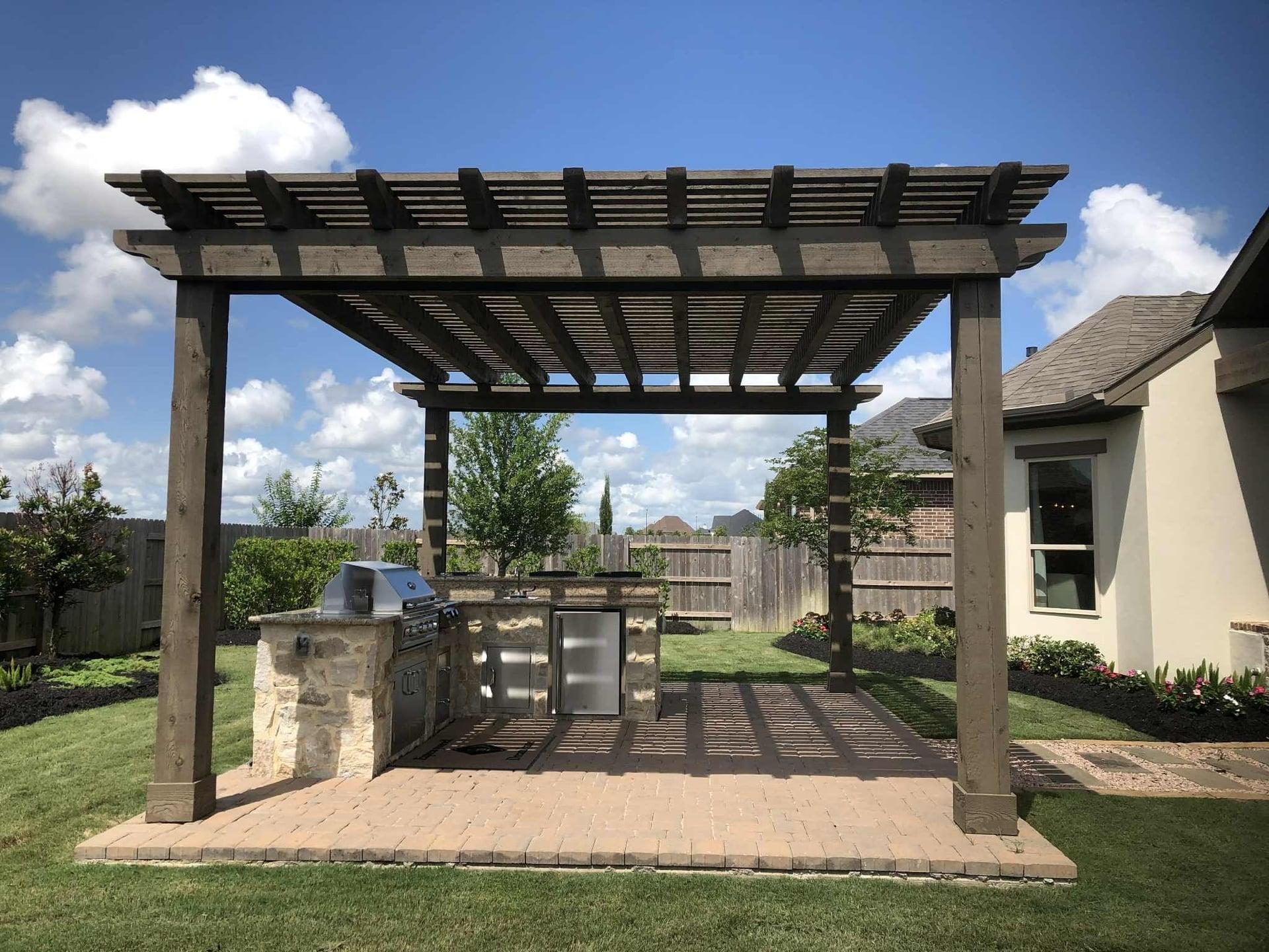 Traditional pergola with outdoor grill on brick paver patio
